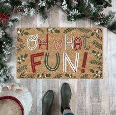 someone standing in front of a door mat that says oh what fun