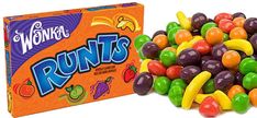 a box of wonka's fruits next to a pile of gummy candies