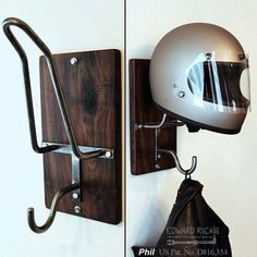 a helmet mounted to the side of a wall next to a pair of metal hooks