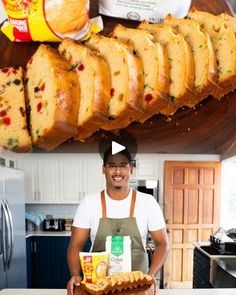 a man standing in front of a cake on top of a counter