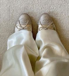 a pair of white shoes sitting on top of a couch