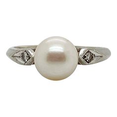 A fine Retro signed pearl cocktail ring.  In 14k white gold.  Set with 7mm round white pearl and flanked by two small accent diamonds on the shoulder of the setting.  Marked to the shank for Rothman & Schneider of New York City.  Simply a wonderful Mid-Century ring!  Date: Mid-20th Century  Overall Condition: It is in overall good, as-pictured, used estate condition with some fine & light surface scratches and other signs of expected light wear consistent with age.  Fineness: Marked 14k for gold Pearl Cocktail Ring, G Ring, Mabe Pearl, Gold Cocktail Ring, White Gold Set, Gold Cocktail, Pearl Diamond, Gold Set, Gold Pearl