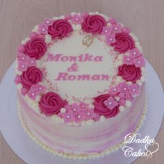 a heart shaped cake decorated with pink flowers and the words montka & roman on it