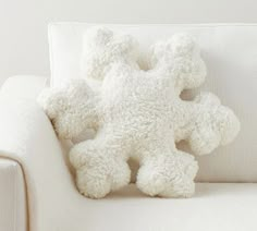 a white teddy bear sitting on top of a couch