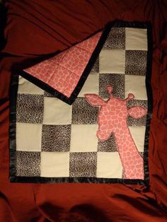 a giraffe quilted on top of a bed