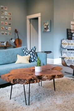 a living room filled with furniture and a wooden table in the middle of the room