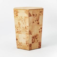 a small wooden vase sitting on top of a white table