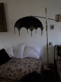 a bedroom with a bed, lamp and pictures on the wall