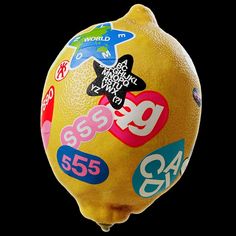 a large lemon with stickers on it's side and the number 955