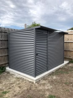 a large metal shed sitting in the middle of a yard