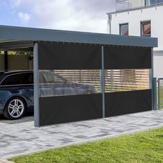 a car is parked in front of a garage with black awnings on it