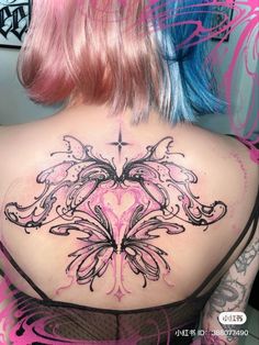 a woman with pink hair and tattoos on her back