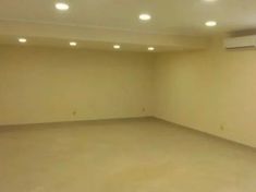 an empty room with lights on the ceiling and no one in it or someone else