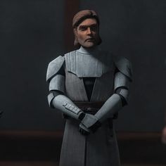 a star wars character is standing in front of two other characters, one with his hands on his hips