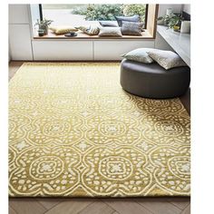 a large yellow rug in front of a window