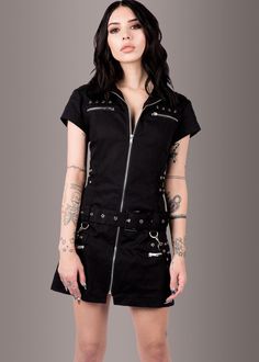 Three cheers for this black mini dress, because dressed in edgy style like this, life doesn’t get any better! This little black dress closes with a front zipper and is accessorized with rad buckles and studded details. Pretty corset lacing in the back adds to the edgy style of the dress as well as to an adjustable fit. Available in sizes XS, S, M, L, XL, XXL and XXXL. This rad dress gives others every reason to celebrate your wickedly awesome look! Measurements SIZE CHART DRESSES XS S M L XL XXL Black Goth Dress, Wednesday Dress, Shaggy Jacket, Gothic Mode, Black Lace Choker, Punk Dress, Emo Dresses, Faux Leather Biker Jacket, Black Goth