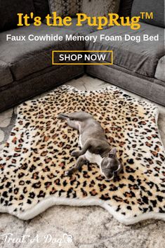 a dog laying on top of a leopard print rug