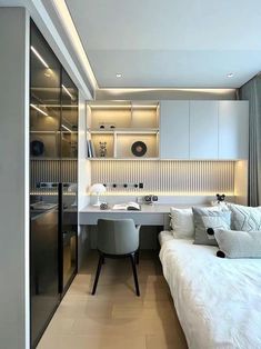 a white bed sitting in a bedroom next to a kitchen