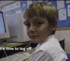 a young boy sitting in front of a computer monitor with the caption it's time to log off