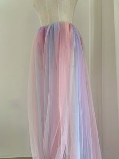 a dress made out of tulle with pink, blue and purple colors on it