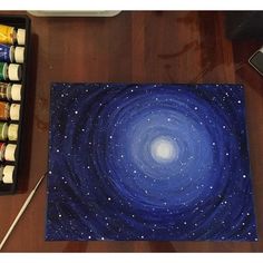 a painting on a table with paint and watercolors