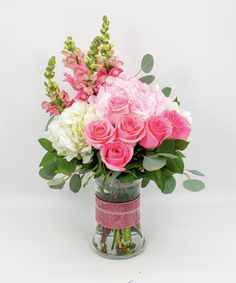 a vase filled with pink and white flowers