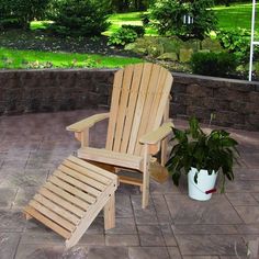 a wooden lawn chair sitting on top of a patio next to a potted plant