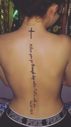 a woman with a cross tattoo on her back