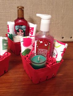 three red baskets filled with personal care items on top of a wooden table next to a wall