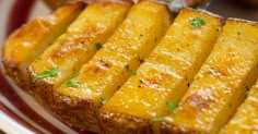 slices of bread sitting on top of a red and white plate with green garnish