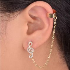 an ear with a chain attached to it and a pair of earrings hanging from the side