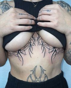 a woman with tattoos on her chest and hands