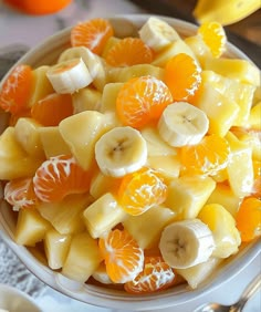 a white bowl filled with sliced fruit on top of a table