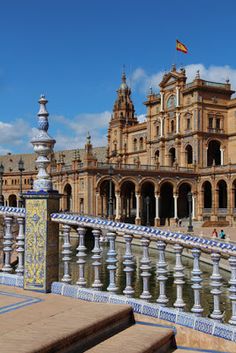 an ornate building with blue and white tiles on the outside, along with steps leading up to it