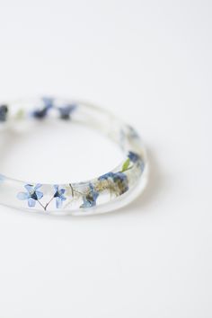 Nee shape of forget me not flower bangle #bangle #bracelet #blue #forgetmenot #flowers #floral #botanical #resin #minimalist #natural Spring Gift Bangle, Spring Wedding Bangle Bracelets, Spring Bangle Jewelry Gift, Spring Gift Bangle Jewelry, Adjustable Flower Bracelets With Pressed Flowers, Handmade Bracelets For Spring Weddings, Handmade Bracelets For Wedding In Spring, Spring Flower Shaped Jewelry With Pressed Flowers, Spring Flower Jewelry With Pressed Flowers