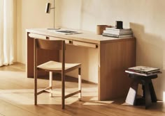 a wooden desk with a chair next to it