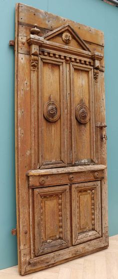 an old wooden door with two knobs on the front and back doors are open