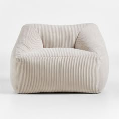 a white chair that is made out of corded fabric and has a rounded shape