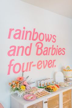 a baby's first birthday party with rainbows and babies four - ever on the wall