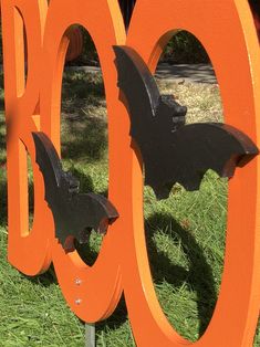 an orange sign with bats on it in the grass