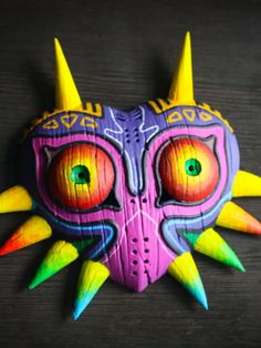 a colorful mask with horns and spikes on it