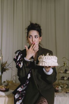 a woman holding a cake in front of her face