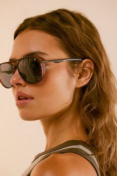 a woman wearing sunglasses looking off to the side