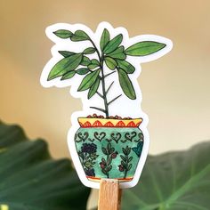 a potted plant sticker sitting on top of a wooden stand