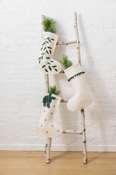 an old ladder decorated with stockings and christmas decorations