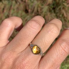 A golden yellow citrine is set in 14k yellow gold with 2.5mm diamonds flanking its shoulders. Finished with a handcarved sterling silver band this beauty is a perfect drop of sparkling sunshine for your finger. Approximate stone size: 10mm x 9mm Approximate stone weight: 2.3 cts Mohs Hardness scale: 7 This one of a kind piece is handmade to with love in Emily's Hudson Valley studio. If you have questions about sizing, shipping or need help deciding please reach out to us! Stacked Engagement Ring, Hardness Scale, Birthstone Stacking Rings, Imperial Topaz, Ray Of Sunshine, Local Jewelry, Yellow Citrine, Citrine Ring, Diamond Shop