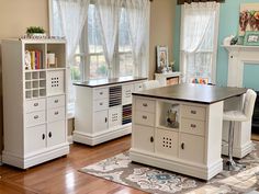 a kitchen with white cabinets and an island in the middle, along with a fireplace