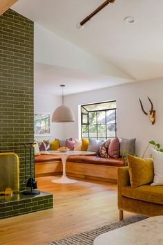 a living room filled with lots of furniture and a fire place next to a window