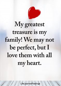 a red heart sitting on top of a wooden table next to a white wall with the words, my greatest treasure is my family we may not be perfect, but i love them