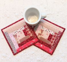 two placemats and a coffee cup on a white tablecloth with red border